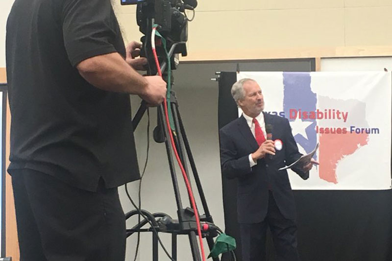 Our livestream crew records emcee Dennis Borel giving opening comments at TDIF in 2018.